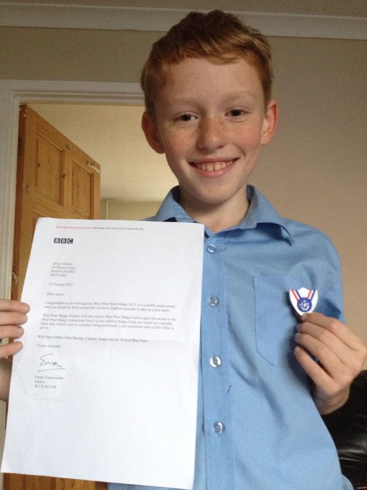 James shows off his Blue Peter badge